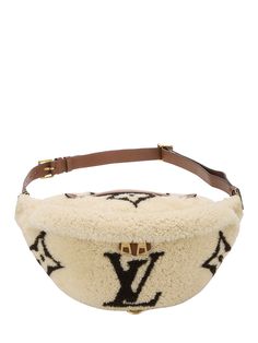 Find LOUIS VUITTON Monogram Teddy Bumbag on Editorialist. The Louis Vuitton Monogram Teddy Bumbag features a shearling construction with a brown leather adjustable strap and buckle closure. This fanny pack can be worn on the hips or on the shoulder. The bag is adorned with the signature Louis Vuitton monogram. Louis Vuitton Teddy Bumbag, Louis Vuitton Teddy, Fanny Pack, Belt Bag, Louis Vuitton Monogram, Brown Leather, Adjustable Straps, Bag Lady, Louis Vuitton