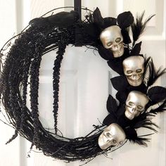 a wreath decorated with skulls and feathers