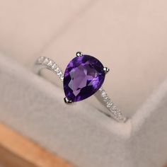 Pear-shaped Birthstone Promise Ring, Silver Pear-shaped Ring With Halo Setting, Elegant Pear-shaped Amethyst Anniversary Ring, Pear-shaped Purple Amethyst Ring With Prong Setting, Purple Pear-shaped Ring With Prong Setting, Purple Pear-shaped Amethyst Ring With Prong Setting, Formal Amethyst Pear-shaped Ring, Elegant Silver Teardrop Amethyst Ring, Elegant Teardrop Amethyst Gemstone Ring