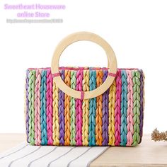 a multicolored handbag with a wooden handle on the front and bottom side