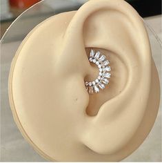 a close up of a fake ear with some diamonds in it's center piece