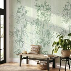 a room with a bench, potted plant and wallpaper on the walls behind it