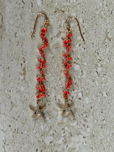 Starfish Earrings featuring a delicate aqua coral rosary chain accented with a CZ starfish.  Gold filled ear wires. Earrings measure 3 inches. Handmade GIFT BOXED Starfish Charm Dangle Jewelry, Coral Dangle Earrings, Gold Starfish-shaped Beaded Jewelry, Red Star Charm Earrings For Gift, Red Star-shaped Beaded Jewelry, Starfish Ear Wire Jewelry As Gift, Starfish Charm Drop Earrings As Gift, Starfish Charm Dangle Earrings For Jewelry Making, Starfish Charm Drop Earrings For Gift