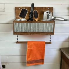 a towel rack with hair dryers and combs hanging from it