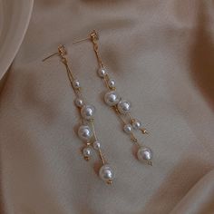 Pearl Dangle Earrings Take a look at our beautiful pearl earring design. These pearl drop earrings have been designed by a nature-originated jewelry designer and are made with faux pearls to give you an affordable and vintage style. Made with shell pearls and silver pins, these pearl earrings are easy to care for and will take your look from casual to formal in an instant. Product Specifications Pearl Type Shell Pearl Pearl Shape Round Pearl Size 6mm / 0.23 inches Length 50mm / 1.96 inches Pearl Pearl Earrings Designs, Bridal Hairdo, Wedding Earrings Drop, Pearl Jewelry Sets, Long Dangle Earrings, Jewelry Lookbook, Fancy Jewelry, Pearl Earrings Dangle, Floral Hair