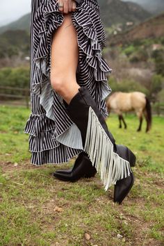 Make a statement with JOYDISTRICT Western boot. Cut from black faux leather with crystal cord fringe accents on the sides, these knee high boots bring a touch of luxury to a classic western style. With modern flair on a cowboy boot, these gorgeous shoes are a must-have for a chic western look Western Boot Outfit, Western Gothic, Black Western Boots, Crystal Fringe, Music Festival Fashion, Azalea Wang, Music Festival Outfit, Western Look, Sandal Platform