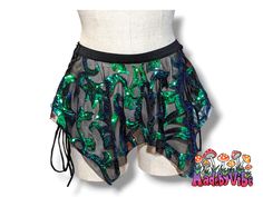 Take a risk and stand out in this handcrafted micro pixie skirt, complete with an elastic waistband and lace-up sides. Perfect for those who love adventure and raves alike. Made to order, pattern placement may vary. Fairy Grunge Bottoms For Summer Festival, Fairy Grunge Style Bottoms For Summer Festival, Fitted Fairy Grunge Bottoms For Costume Party, Green Mini Skirt For Festival, Rave Festival Skirt With Stretch, Stretch Rave Skirt For Festival, Micro Pixie, Diy Rave Outfits, Pixie Skirt