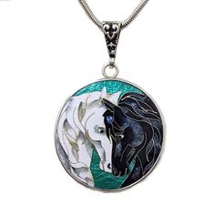 Cloisonné Facing Horses Pendant Necklace. This stunning piece showcases the intricate art of cloisonné, where vibrant enamel is delicately hand-applied within the borders of fine metalwork. It features two Horse Heads on an iridescent teal background on one side, and a woman silhouetted against a horse on the other, set in a Sterling Silver bezel. The facing horses, resting their faces gently against each other symbolize grace, friendship, love, making it a perfect emblem for those who cherish these qualities. And the reverse side embodies how we can be one with our horses. The Cloisonné Facing Horses Pendant Necklace is 1-1/4” in diameter and hangs 1-3/4” from its ornate bail. Comes on an 18” Sterling Silver chain. A polishing cloth is included with the necklace. Ready to Ship. Gift Boxed Luxury Enamel Inlaid Jewelry, Luxury Silver Jewelry For Art Collection, Luxury Silver Jewelry With Inlay, Artistic Enamel Jewelry For Formal Occasions, Artistic Multicolor Jewelry For Formal Events, Artistic Multicolor Jewelry For Formal Occasions, Artistic Multicolor Formal Jewelry, Elegant Necklace With Artistic Round Pendant, Traditional Engraved Enamel Necklaces