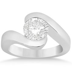 a white gold ring with a round diamond in the center and a curved band around it