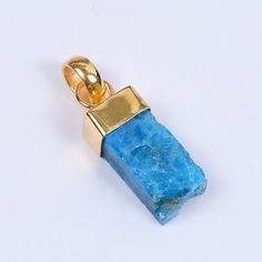 Classic designs never die and this handcrafted blue apatite is a one beauty that you will desire to wear forever. The raw gemstone and brass pendant is not only unique with its classic cut but also, deeply thoughtful for the embedding of the bezel stone in a tiny design, keeping in sync with the minimalist trend, making it the perfect gift for your special lady.  Handmade 18k Gold Plated Raw Apatite Birthstone Jewellery Suppliers, Minimalist Pendant, Drop Pendant, High Quality Jewelry Making Sup Blue Minimalist Aquamarine Jewelry, Blue Raw Stone Spiritual Jewelry, Spiritual Blue Raw Stone Jewelry, Blue Minimalist Rectangular Pendant Jewelry, Minimalist Gold Jewelry With Blue Topaz, Minimalist Gold Aquamarine Jewelry, Blue Raw Stone Jewelry For Gift, Sapphire Colored Kyanite Jewelry As A Gift, Handmade Apatite Jewelry As Gift