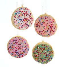 three cookies with sprinkles hanging from strings