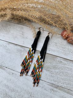 Long Beaded Tassel Earrings Beaded Earrings Southwestern Seed Bead Earrings Triangular Style Earrings Western Style Turquoise White Earrings These fun earrings are a great addition of color to any outfit! Very lightweight and eye catching!  Handmade with glass seed beads and paired with an antique gold earwire.  Length is approximately 4 inches in length. All designs, photos, and descriptions are property of TwistedRiverDesign! All designs, photos, and descriptions are property of TwistedRiverDesign! Bohemian Black Beaded Dangle Jewelry, Southwestern Style Beaded Dangle Earrings For Festival, Southwestern Style Dangle Beaded Earrings For Festivals, Southwestern Dangle Beaded Earrings For Festivals, Southwestern Beaded Earrings With Tassels For Festival, Southwestern Dangling Beads For Jewelry Making, Bohemian Adjustable Beaded Earrings, Southwestern Black Festival Earrings, Southwestern Fringe Beaded Earrings As Gift