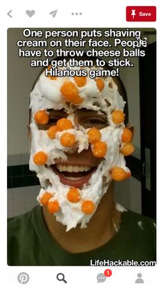 a man is smiling while wearing a white mask with orange candies all over his face