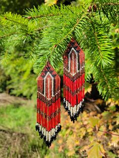 Beautiful beaded earrings Native inspired. A sure head turner with these beautiful colors. Made with delica beads in a brick stitch pattern. Red, silver, and black. A unique gift for a special person....or keep for your own collection.  https://shelbyswolfvisions.etsy.com Native Beaded Earrings, Beautiful Beaded Earring, Native Beading, Native Beading Patterns, Beaded Earrings Native, Brick Stitch Pattern, Delica Beads, Brick Stitch, Special Person