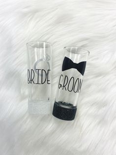 two bride and groom tumblers sitting on top of a white furnishing floor