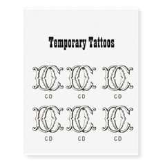 temporary tattoos with the letters c and d in black ink on white paper, set of 6