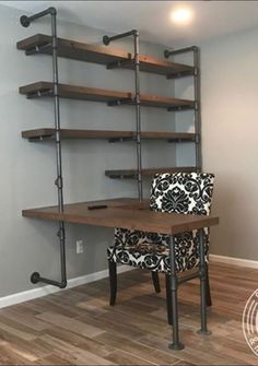 a room with a desk, chair and shelving unit