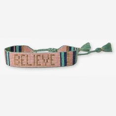 the beaded bracelet is pink, green and blue with words that spell out sleep