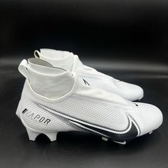 a pair of white soccer shoes on a black surface with the word vapor written across the sole