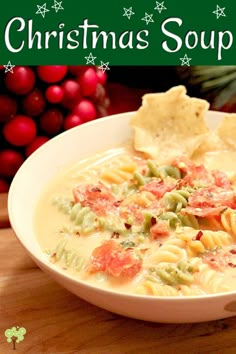 a bowl of christmas soup with tortellini crackers and holly wreaths in the background