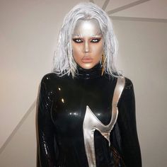 a woman with silver hair and black latex outfit