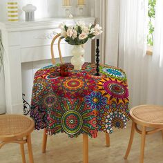 a colorful table cloth with flowers on it in front of a fire place and fireplace