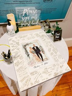 a table with a wedding card and other items on it