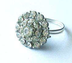 "This sparkly and elegant coctail ring is handmade from a silver toned vintage button that has been reimagined and wired onto a ring base. The rhinestones sparkle beautifully and set with a lovely art deco look.  The vintage element is 3/4 of an inches in diameter. It really makes a statement. The button is in good condition for its age but there is some discoloration on the metal and in the rhinestones.  This gives it a lot of character and a lovely \"estate\" charm.  Please look at the picture Adjustable Crystal Ring With Rhinestones, Adjustable Crystal Rhinestone Ring, Vintage Silver Rings For Party, Vintage Adjustable Silver Crystal Ring, Vintage Rhinestone Rings For Gifts, Vintage Rhinestone Rings As A Gift, Vintage Rhinestone Rings For Gift, Vintage Adjustable Crystal Ring For Formal Events, Vintage Adjustable Crystal Ring For Formal Occasions