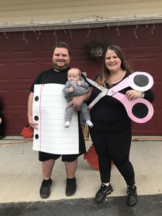 a man and woman dressed up in costumes for halloween with a baby on the nose