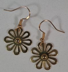 Dangle Earrings Gold Daisy's are just over 1.25 inches. These cute flowers were apart of another piece of jewelry that I picked up at a store closing a little while back. I dissembled the piece and left it plain. I feel like they turned out simple yet elegant. Fun for everyday especially in the spring or summer. Spring Flower Shaped Nickel Free Earrings, Spring Flower-shaped Nickel-free Earrings, Metal Flower-shaped Earrings For Spring, Flower-shaped Metal Earrings For Spring, Spring Gift Pierced Earrings, Spring Gift Earrings For Pierced Ears, Spring Flower-shaped Metal Earrings, Spring Gift Earrings, Metal Flower Charm Earrings For Spring