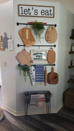 there is a wall mounted with cutting boards and other kitchen utensils on it