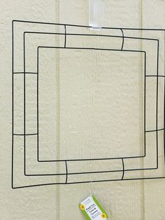 a piece of paper taped to the side of a wall with a square drawn on it