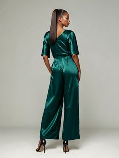 This soft satin jumpsuit features a flattering v-neck design, making it the perfect choice for mothers of the bride. Its dress pantsuit style provides comfort and elegance, while its high-quality material ensures a polished look. Stay stylish and comfortable on that special day with our jumpsuit. Satin V-neck Jumpsuits And Rompers For Party, Elegant Satin Jumpsuit Or Romper In Solid Color, Satin Jumpsuit With V-neck For Party, Party Satin V-neck Jumpsuits And Rompers, Satin V-neck Jumpsuit For Party, Formal Satin V-neck Jumpsuit, Green V-neck Jumpsuits And Rompers For Evening, Elegant Satin Pantsuit For Evening, Elegant Green Evening Pantsuit