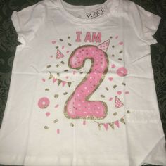 NWT I am 2 years old birthday shirt sz 3t 3 brand new with tags from tcp the childrens place size 3t 3 shirt top short sleeves for the birthday girl who is turning 2 years old great present for her to wear to her birthday party or wear all year long to remember just exactly how old she is has the number 2 large on it with a party hat and lots of confetti reads I AM and then the year old number glitter gold design along with the pink 2nd birthday I have mutiples available for sisters twins triple Gold Tops With Letter Print For Gifts, Pink Glitter Print Top For Birthday, Gold Top With Graphic Print For Birthday, Gold Graphic Print Top For Birthday, Gold Top With Graphic Print, Gold Letter Print T-shirt For Party, Gold Short Sleeve Top As Gift, Gold Short Sleeve Tops With Glitter Print, Gold Short Sleeve Top With Glitter Print