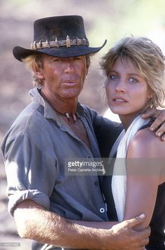 a man in a cowboy hat hugging a woman on the set of'indiana jones '