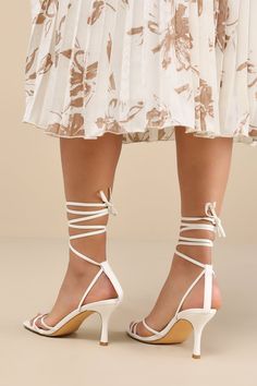 Make an entrance unlike any other with a fabulous look like the Lulus Lawrance White Lace-Up High Heel Sandals! Smooth faux leather shapes these trendy lil' heels that feature a classic square-toe footbed, a network of slender straps that create a peep-toe upper, and matching straps that weave through a supportive heel strap to wrap and tie above the ankle. 3. 25" wrapped stiletto heel. Cushioned insole. Rubber sole has nonskid markings. Man made materials. Imported. Lulus | Lawrance White Lace-Up High Heel Sandal Heels | Size 10. White Square Toe Heels With 4-inch Heel, Elegant Fitted Sandals With Square Toe, Low Heel Heels For Spring Gala, Elegant Square Toe Fitted Sandals, Elegant Fitted Square Toe Sandals, Event Sandals With Padded Heel And Fitted Style, Event Sandals With Padded Heel And Fitted Design, Chic Square Toe Heels With Wrapped Heel, Event Sandals With Padded Heel