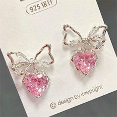 Pink Crystal Bowknot Heart Dangle Earrings These adorable Pink Crystal Bowknot Heart Dangle Earrings are the perfect accessory for any fashion-forward person. Made with high-quality materials and adorned with pink crystals, these earrings will add a touch of sweet charm to any outfit. The heart-shaped design and delicate bowknot detail make these earrings simply irresistible. Pretty Earrings Aesthetic, Pretty Jewelry Necklaces, Jewelry Accessories Ideas, Girly Accessories, Heart Dangle Earrings, Classy Jewelry, Fancy Jewellery, Jewelry Lookbook, Fancy Jewelry