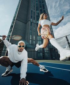 two tennis players jumping in the air with rackets