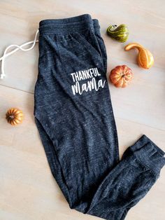 Thankful Mama Joggers They are super soft and comfortable Ribbed cuff Natural draw string to adjust size Made 30 percent cotton 50 percent polyester 20 percent raylon Womens sizing Washing instrustions Wash on cold and inside out dry on delicate. Available in Camo and Eco Black Thankful Mama, Mom Pants, Mama Sweater, Mama Hoodie, Camo Sweatshirt, Blessed Mama, Womens Trousers, Mom Hoodies, Bear Hoodie