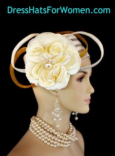 Ladies 1920's Style Flapper Art Deco Era Ivory Metallic Gold Pillbox Church Wedding Bridal Cocktail Hat. This Formal Straw Braid Hat Is Embellished With A Large Ivory Double Loop Bow Enhanced With Clear Acrylic Rhinestones, Accented With Two Metallic Gold Double Looped Bows. A Large Ivory Millinery Silk Flower With A Large Pearl Center Is Placed In The Center Of This Beautiful Custom Made Bow.  Four Rows Of Rhinestones Encircle The Crown Of This Fashion Wedding Headpiece. This Designer Hat Is Su Gatsby Style Wedding Hat And Headpieces, Gatsby Style Costume Hat For Wedding, Fitted Flapper Hats For Wedding, Fitted Beige Fascinator For Vintage Events, Fitted Flapper Wedding Hat, Cream Gatsby Hat For Wedding, Gold Gatsby Headpiece For Vintage Events, Flapper Style Fitted Wedding Headpiece, Fitted Flapper Wedding Headpiece