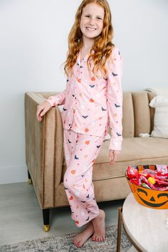 We have the perfect pjs for you this spooky season! They are so cute with all those little ghostys, bats, and pumpkins! This pjs set is sure to be a fan favorite especially since we also carry this set in adult sizes so you and your mama can match this Halloween season! Top: Collared neckline Button down front closure Long sleeves White piping Halloween print Generous stretch Bottoms: Elastic waist Halloween print Generous stretch Glory is wearing the medium. Cute Fall Sleepwear For Pajama Party, Cute Sleepwear For Pajama Party In Fall, Cute Sleepwear For Sleepover In Fall, Cute Sleepwear For Sleepover, Fun Long Sleeve Sleepwear For Pajama Party, Playful Fall Loungewear Sets, Playful Loungewear Sets For Fall, Cute Cotton Halloween Sleepwear, Playful Pajama Party Sets For Fall