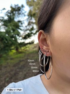 Item Details: This is for 1 Pair (= 2 Pieces). Size:  * 30mm  * 40mm  * 50mm  * 60mm  Item Details: The earrings are for 1 PAIR and only come in the CLIP-ON version for NON-PIERCED ears. These stainless steel clip-on hoop earrings use a spring closure and look very realistic (like pierced earrings). More color/size: * Silver Small (11-18mm): https://clipsody.etsy.com/listing/1447440109  * Gold Small (11-18mm): https://clipsody.etsy.com/listing/1427933739 * Gold Large (30-60mm): https://clipsody.etsy.com/listing/1732357881  * Rose Gold Small (11-18mm): https://clipsody.etsy.com/listing/1564368041  * Rose Gold Large (30-60mm): https://clipsody.etsy.com/listing/1718185720  Shipping: * US customers: Receive FREE US shipping by making an order of $35 or above from my shop. * Non-US customers: I Earrings No Piercing, Earrings For Men, Earrings Clip, Earrings Minimalist, Pierced Earrings, Silver Hoops, Pierced Ears, Minimalist Earrings, Earings Piercings