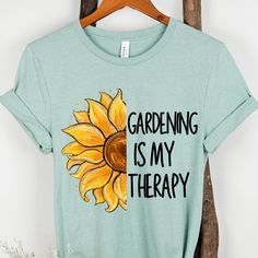 Hi, Welcome to Our Store! Embrace the tranquility of nature with our 'Gardening is my Therapy' shirt! Perfect for garden lovers and Plant Lover, this soft and comfortable tee is adorned with a charming garden-themed design. Whether you're tending to your blooms or simply enjoying the beauty of the Gardener, let this shirt remind you that life truly flourishes in the garden. Available in a variety of sizes and colors, it makes a delightful addition to any wardrobe or a thoughtful gardening gift f Relaxed Fit Graphic Print Shirt For Gardening, Relaxed Fit Shirt With Graphic Print For Gardening, Green Plant Print Tops For Gardening, Green Tops With Plant Print For Gardening, Short Sleeve Shirt For Gardening In Spring, Spring Gardening Short Sleeve Tops, Relaxed Fit T-shirt For Gardening In Spring, Cotton Shirt For Gardening In Summer, Summer Cotton Shirt For Gardening