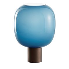 a blue vase sitting on top of a wooden stand