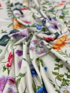 an image of a flowered fabric that is very colorful and has many flowers on it