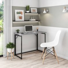 a laptop computer sitting on top of a desk next to a white chair and potted plant