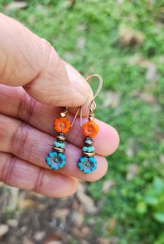 Love turquoise and orange together!  You have probably already observed that! These boho beauties are a gorgeous stack of Czech glass orange and turquoise flowers paired with a stack of copper and turquoise beads.  Yummy! The petite stacked bead earrings are 1 3/4 inches in length, including the copper hooks.  The bottom flower is 3/8 inch wide.   Bring on the Spring/Summer! Great for the beach, running errands, for work or a date night.  Versatile. Handmade. One of a kind design.  Unique boho l Vintage Turquoise Flower Earrings, Bohemian Multicolor Earrings With Flower Charm, Multicolor Bohemian Earrings With Flower Charm, Bohemian Multicolor Flower Charm Earrings, Turquoise Flower Earrings For Summer, Orange Flower-shaped Jewelry For Beach, Orange Flower Jewelry For Beach, Orange Flower-shaped Beach Jewelry, Blue Bohemian Flower Earrings