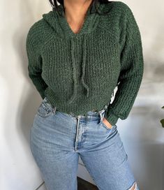 CROPPED HOODIE SWEATER GIVE YOUR EDGY STYLE SOME TRENDY UPGRADE!  SHOWCASING A KNITTED CONSTRUCTION THAT IS PERFECT FOR THE EARLY FALL SEASON, IT FEATURES A HOODED NECKLINE WITH DRAWSTRINGS AND LONG RAGLAN SLEEVES. THE LOOSE-FIT CROPPED BODICE ENDS AT A RAW EDGE HEM. 90% ACRYLIC / 10% POLYESTER MODEL IS  WEARING A SIZE SMALL Color:  HUNTER GREEN Small:2/4 Medium:6/8 Large: 10/12 FREE SHIPPING!! Trendy Stretch Sweater With Drawstring Hood, Trendy Cozy Fit Soft Knit Sweatshirt, Comfy Green Hoodie For Fall, Comfy Long Sleeve Sweater With Drawstring Hood, Casual Cozy Fit Sweater With Drawstring Hood, Trendy Cozy Knit Sweatshirt, Casual Stretch Sweater With Drawstring Hood, Comfortable Knit Sweatshirt In Trendy Style, Comfy Stretch Winter Sweatshirt