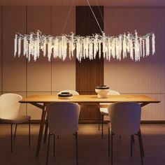 a dining room table with white chairs and a chandelier hanging from the ceiling