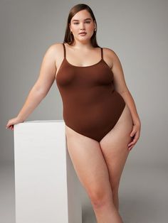 Savage, seamless, and super smooth, our Seamless Bodysuit Teddy was designed for all-day comfort and features a scoop neckline, high-leg bikini, and a logo accent in back. Made from a soft, seam-free material that stretches over your curves and holds you in all the right places. Full Coverage Swimwear With Built-in Bra And Minimal Stretch, Seamless Second-skin Bodysuit For Loungewear, Smoothing Bodysuit With Minimal Stretch For Loungewear, Seamless Full Coverage Swimwear With Minimal Stretch, Shapewear Swimwear With Built-in Bra And Minimal Stretch, Shapewear Swimwear With Built-in Bra, Compressive Seamless Shapewear Swimwear, Scoop Back Swimwear With Minimal Stretch, Compressive Seamless Swimwear